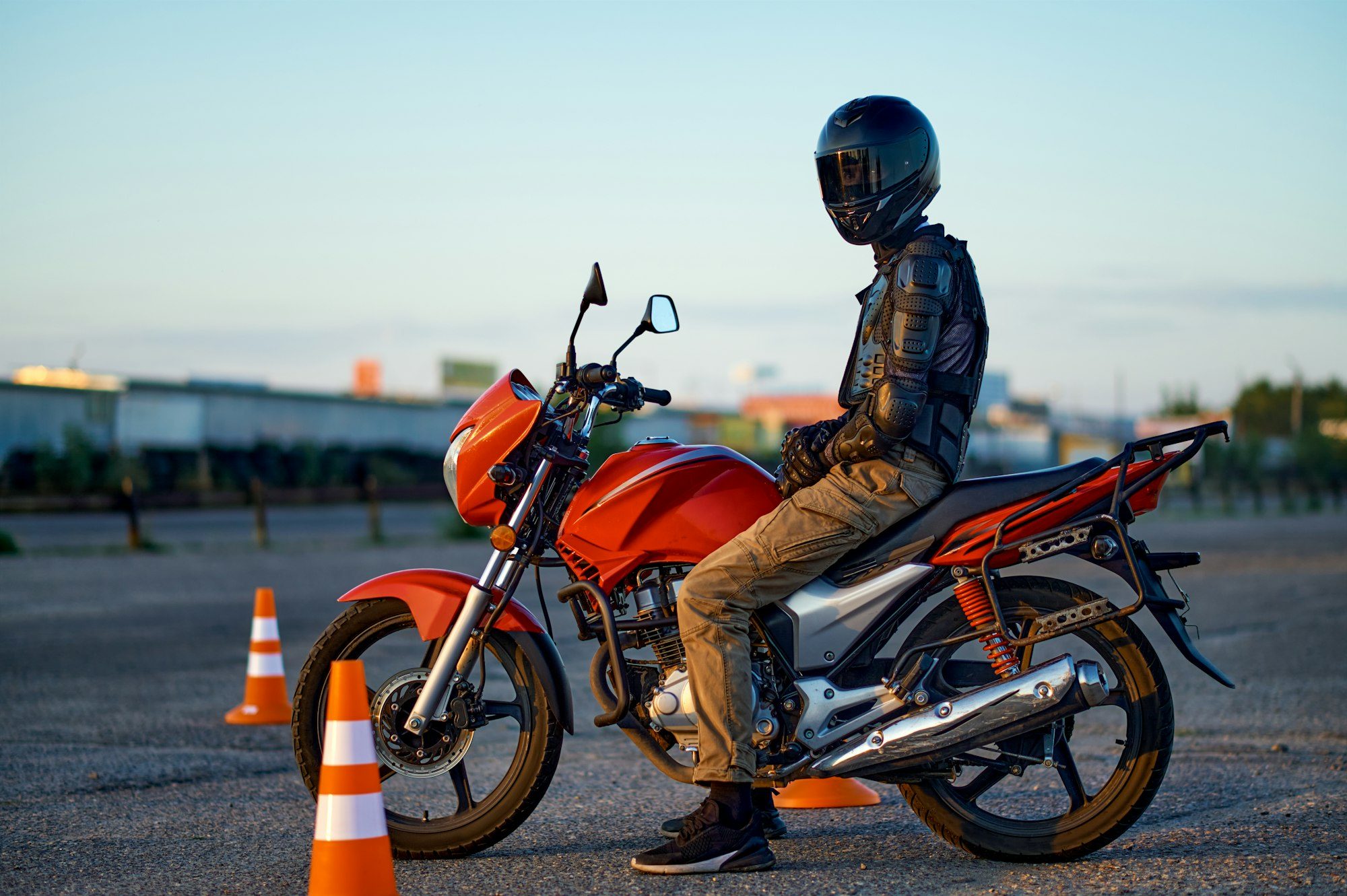 Male student poses on motorbike, motorcycle school